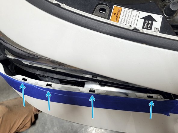 Push four clips under each headlight into place