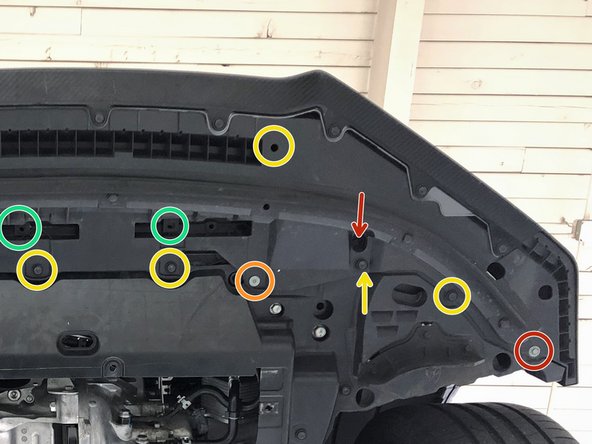 From the underside of the front bumper, remove: