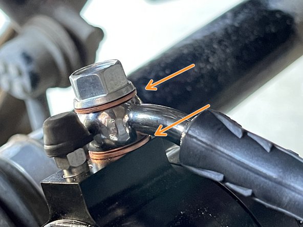 Attach the brake hose to the parking brake assembly with (2) crush washers as shown