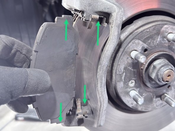 The top and bottom of the 27WON brake pads align into the groove of the brake pad retaining hardware as shown