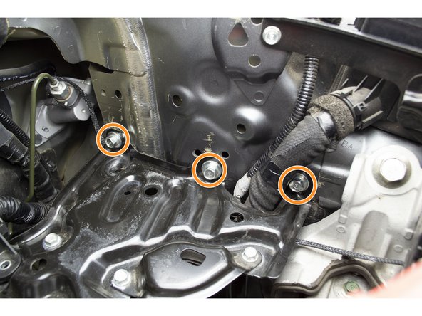 With the bracket in place, install the 3 upper 12mm bolts with a 12mm socket and ratchet