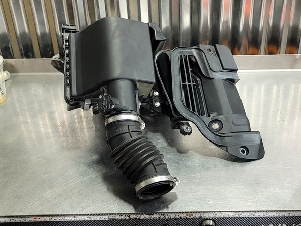 Wiggle the airbox and pull it up at the same time to loosen the airbox from the rubber bushing