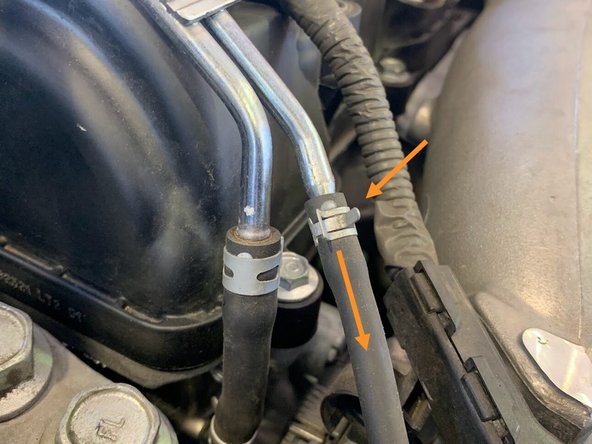 Using needle nose pliers, undo the clamp as shown and free the rubber hose from the hardline