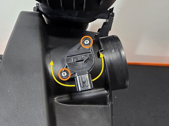 Using a philips head screw driver remove the two screws holding the MAF sensor into the OE airbox