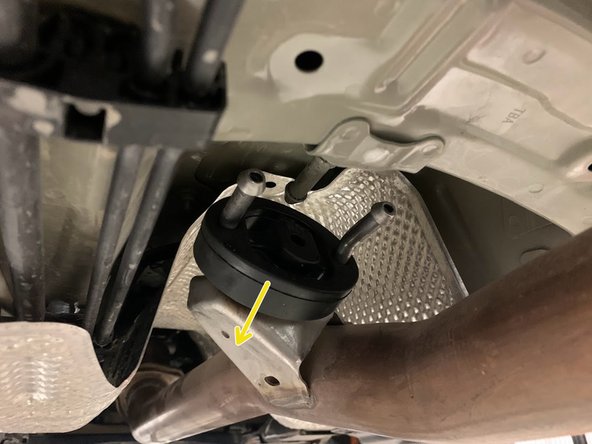 Use tongue &amp; groove pliers to press the rod out of the rubber hanger. Remove the hangers of the exhaust from the rubber supports as shown