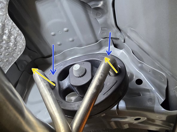 Using a spray cleaner, lubricate the front hangers and rubber support