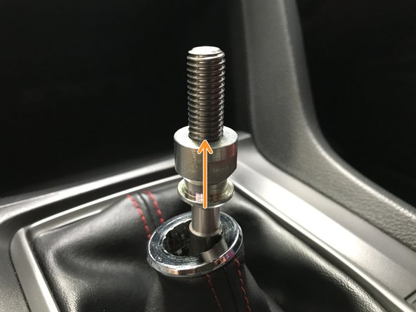 Unthread the OEM locking nut
