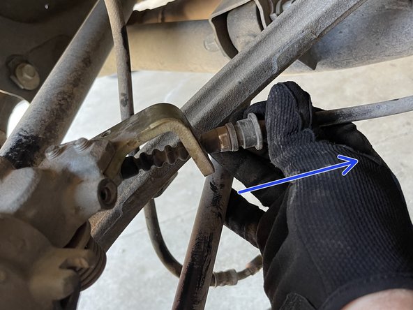 Remove the parking brake cable from the metal bracket