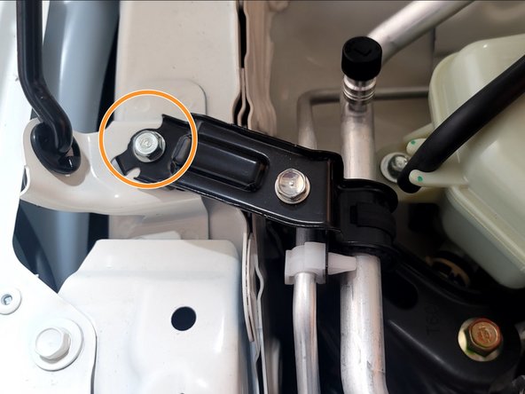 Use a 3/8" ratchet and 10mm socket to remove the 10mm bolt securing the A/C hardline