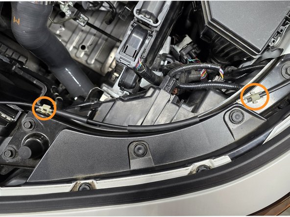 Using you hand or a pair of pliers pinch the sides of the plastic clips holding the hood latch wire in place and lift to remove them