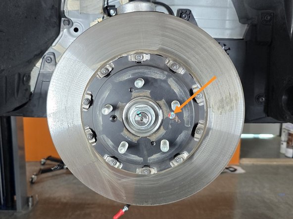 Use a #3 Phillps screwdriver to remove the rotor retention screw