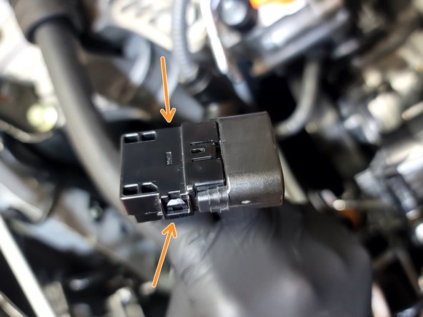 Pop both clips on wastegate actuator plug as shown