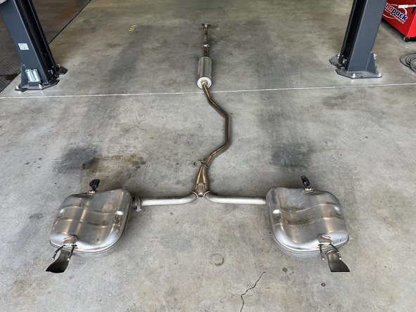 With the exhaust unbolted and removed from the hanger supports, remove from the car and set aside