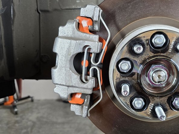 Reinstall your wheels at this time and safely get your car back on the ground before proceeding to bedding your new pads