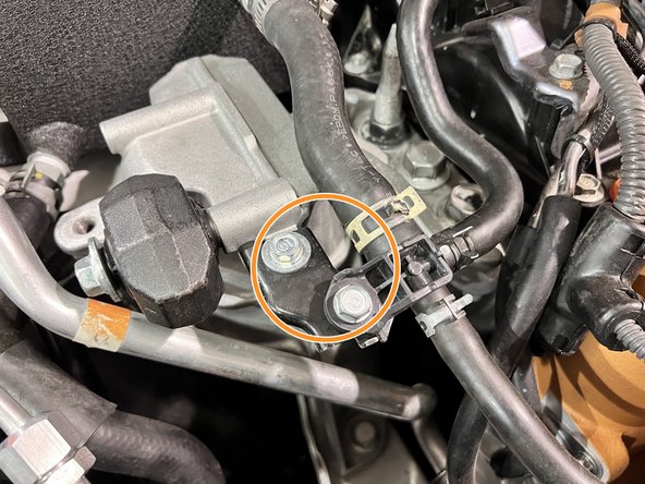 Reinstall the A/C line bracket with the 10mm bolt. Torque to snug