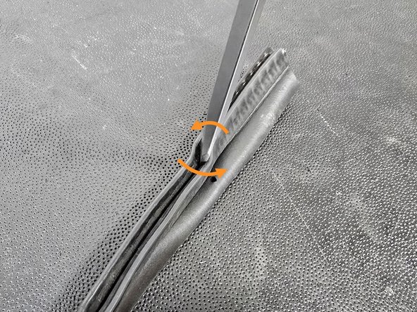 Installing the weather stripping is difficult on the corners. If you run into trouble getting it to set all the way down on the shroud, use a flat head screw driver to spread the mounting seal as shown