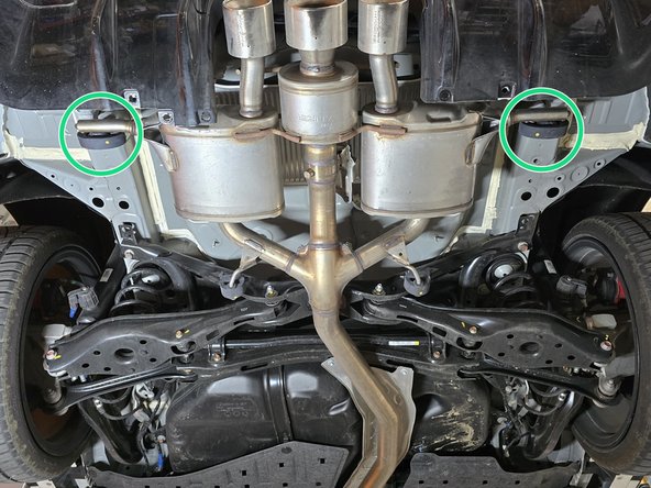 Using a spray cleaner, lubricate the remaining rear hangers and rubber supports