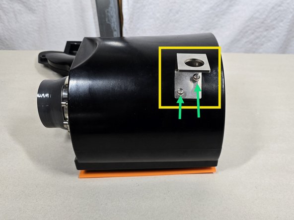 Using the provided two (2) short M5 cap screws mount the lower bracket in the orientation shown