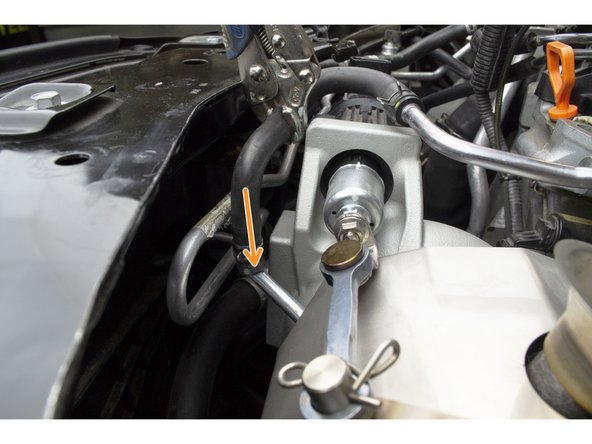 Push the rubber coolant hose onto the turbo upper coolant pipe