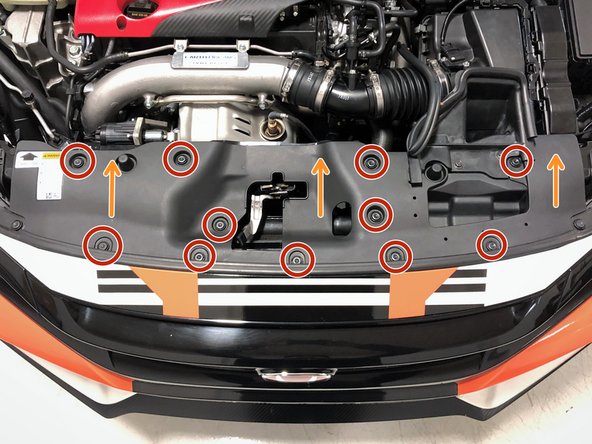 Remove the eleven push clips that attach the radiator cooling panel to the vehicle using a flathead screwdriver or push clip removal tool