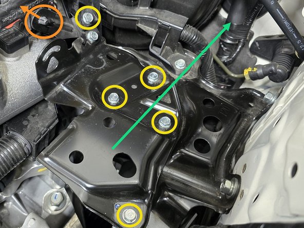 Use your fingers or a pair of pliers to pinch the clip circled in orange and push it out of the bracket