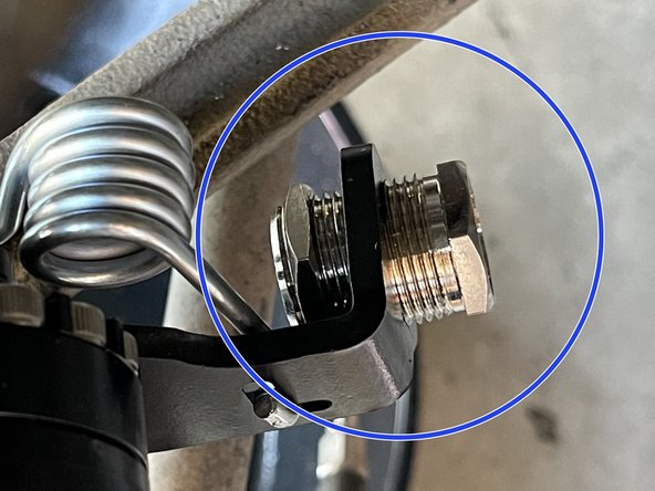 The parking brake assembly has an adjuster screw to adjust brake cable tension