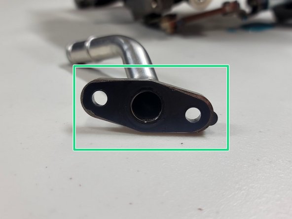 OE gasket should come off with the drain line. This is reused