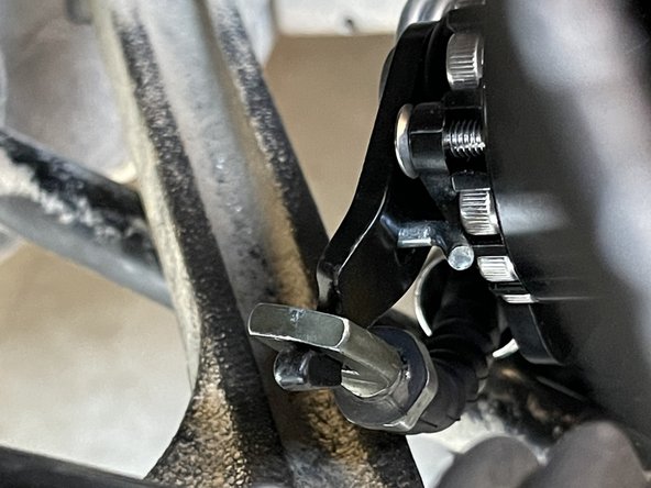 If the cable does not have enough slack to be hooked on, you will have to loosen the parking brake cable nut under the center console