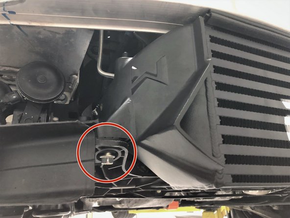 Secure the passenger's side by threading  the other supplied M10 bolt a few turns into the intercooler