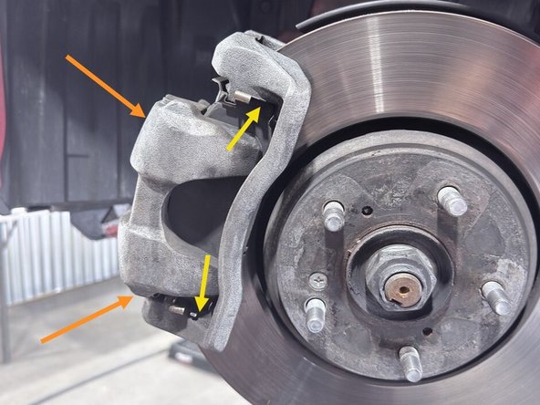 Slide the caliper over the 27WON brake pads and OE rotor as shown