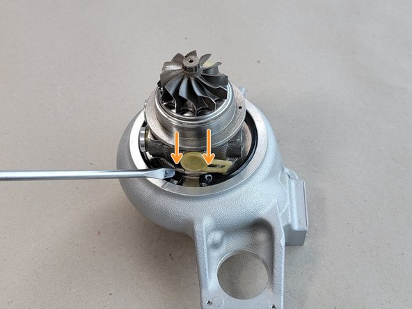 Press the two end tabs into the groove with a flathead screw driver