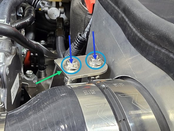 Place the provided M6 washers over the clamp studs as shown