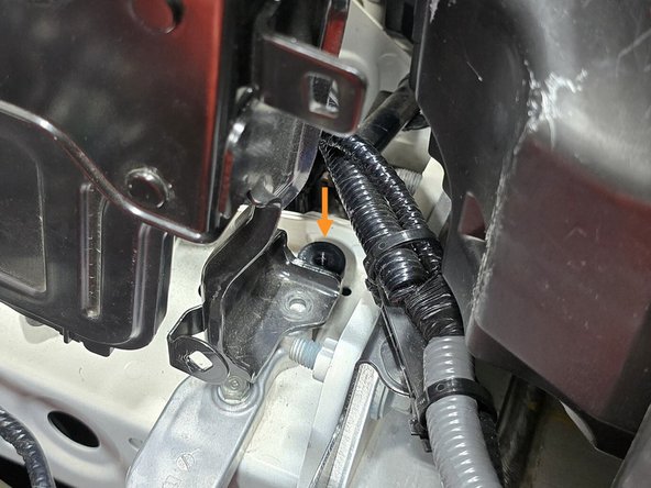 With the bolts removed, place the provided black spacer over the hole closest to the drivers side as shown