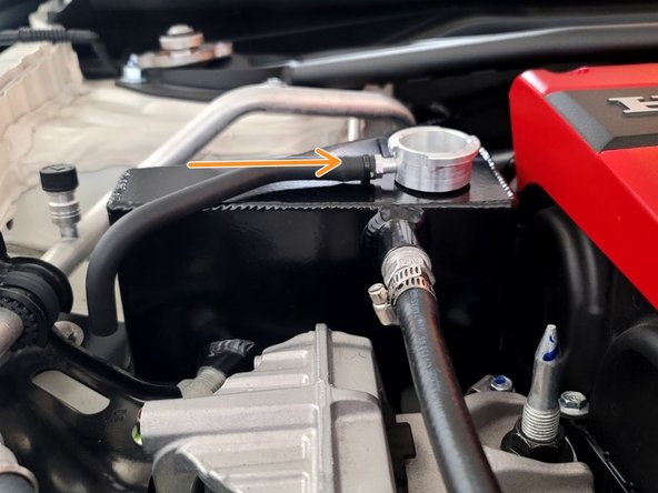 Install OEM overflow hose onto 27WON tank by pushing it on barb as shown