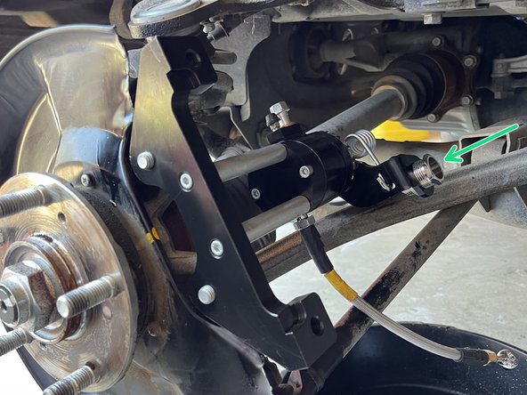 Guide the parking brake cable through the adjustment screw