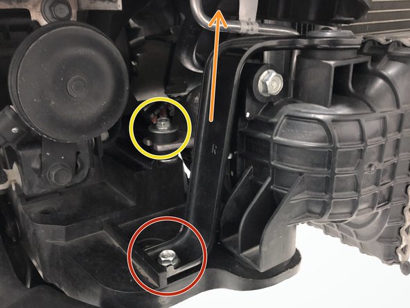 Remove the 10mm bolt from the OEM hot side mounting bracket on the passenger side of the vehicle using a 10mm socket and ratchet