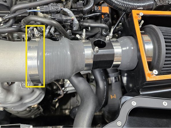 Using a 10mm socket re-tighten the 95-103 T-bolt clamp