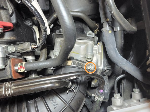 Using pliers pinch the clamp securing the hard line in the intake tube and slide clamp up