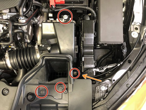 Remove the four 10mm bolts that attach the OEM intake to the vehicle using a 10mm socket and ratchet