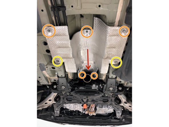 Reposition the front-pipe heat shield by sliding the front edge above the 27WON front-pipe as shown