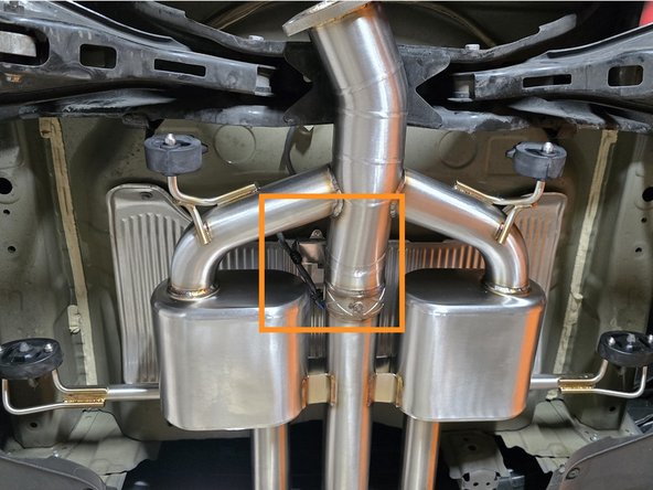 Reaching above the hanging axle back section, plug the valve motor back in with your hand as shown