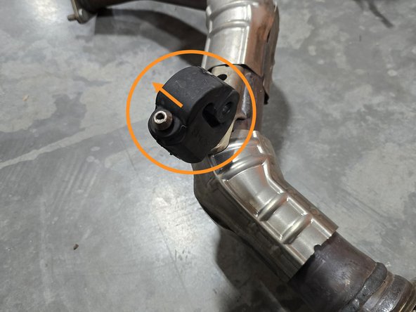 Using a spray cleaner, lubricate the front pipe hanger and remove it from the OE front pipe using a hanger removal tool