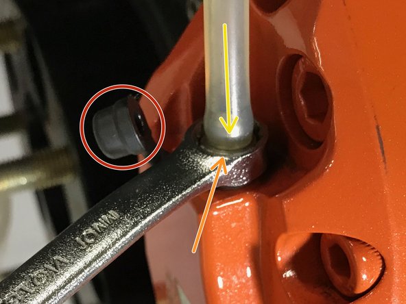 Remove the cap from the bleed screw as shown