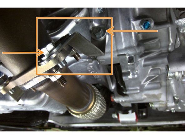 Install the provided driver side bracket as shown. Torque bolt to 33 ft-lbs