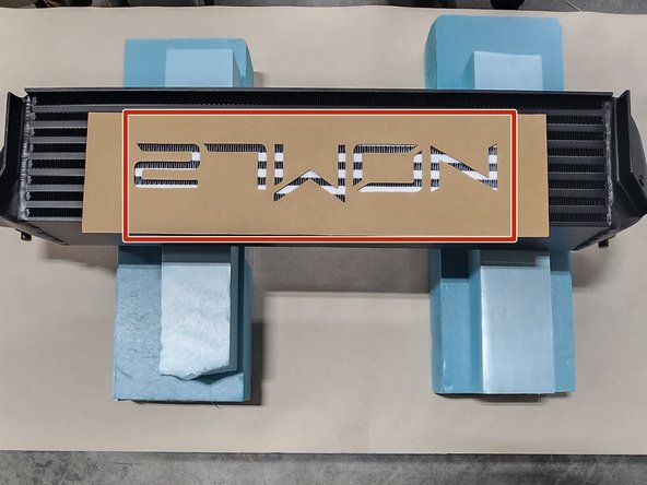 Center the stencil over the existing logo