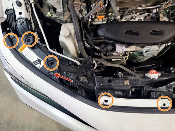 Use a large flathead screwdriver or prying tool to remove the ten (10) push-clips on the top of the bumper