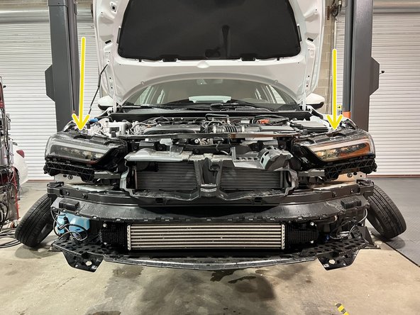 Grab bumper with both hands near hood latch and walk it off the car