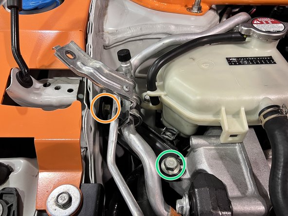 Use a 14mm socket and ratchet or wrench to remove the (2) 14mm bolts securing the side engine mount auxiliary bracket