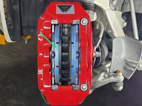 Verify the brake pad material surface is towards the rotor face and the backer plate is towards the pistons
