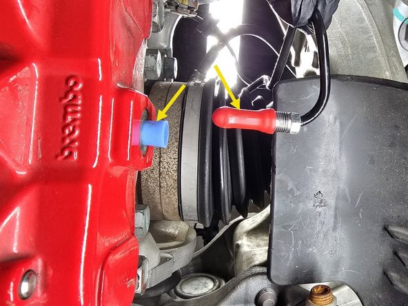 Moving to the back side of the brake caliper, use a 10mm line wrench to remove the brake hardline fitting from the caliper